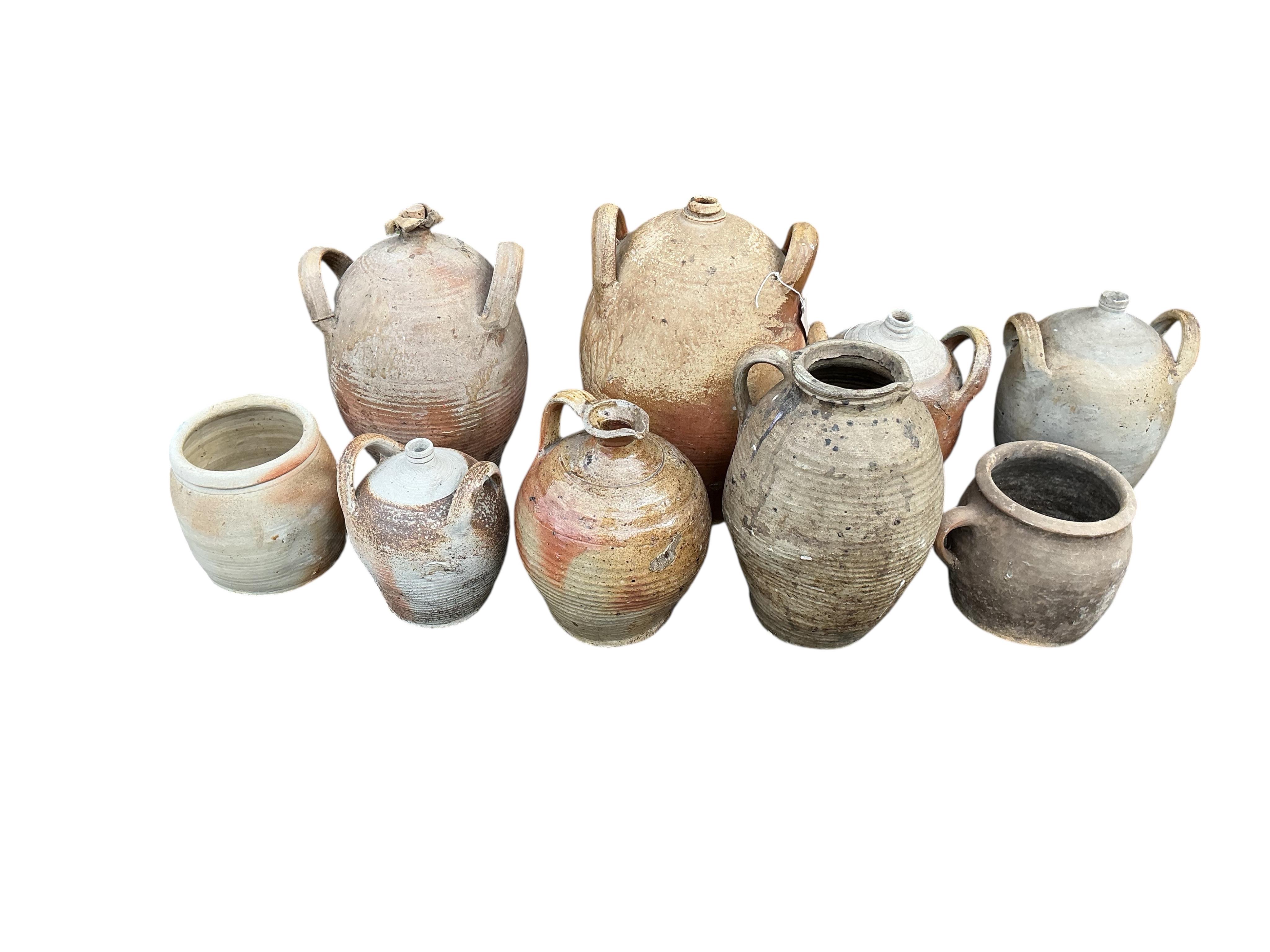 Nine earthenware containers, largest height 41cm